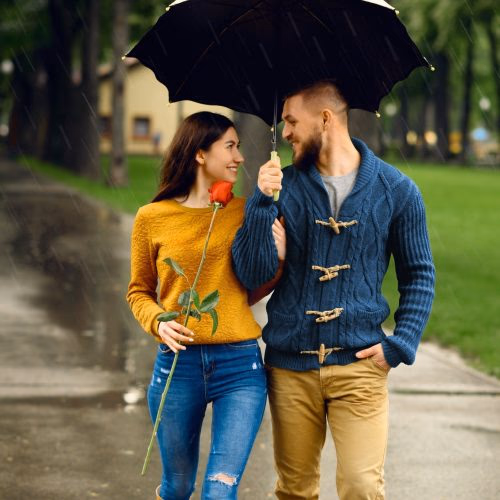 romantic-couple-with-umbrella-walking-in-park.jpg
